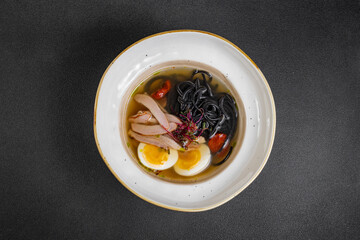 chicken noodle soup. curry soup close-up Japanese food Chinese dish. chicken soup with turkey and black spaghetti.