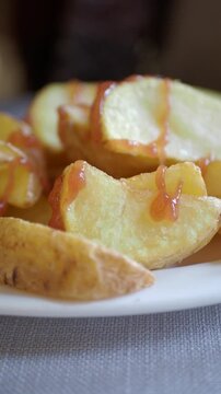 Crispy golden baked potatoes served on white dish
