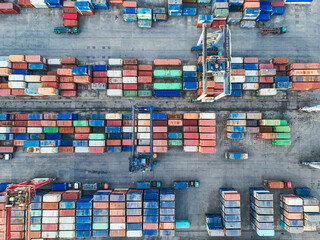 Industrial shipping containers stacked high, representing global trade, export, and logistics power