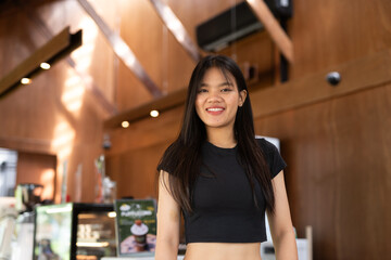 young woman in a cafe bar smiling and looking at camera