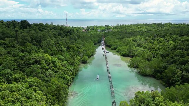Maratua, Indonesia: Aerial time wrap footage of the jetty in the Maratua lagoon and island near Derawan in Indonesia. Shot with an upward and backward motion.