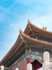 Ornate Chinese imperial palace roof with yellow glazed tiles and intricate painted dougong brackets. Detail of Forbidden City (Palace Museum), Beijing, China.