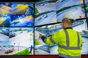 An expert inspector is inspecting the problematic traffic lights to discuss installing new traffic...
