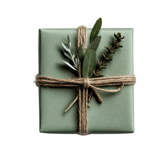 Beautifully wrapped gift box in green paper, adorned with natural twine and sprigs of greenery, exuding rustic and eco friendly charm