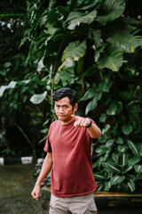 Serious man pointing at you in a vibrant green outdoor setting