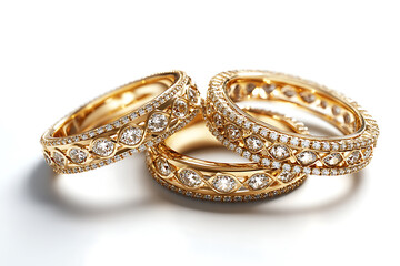 Elegant gold wedding bands with diamonds stacked on a white background