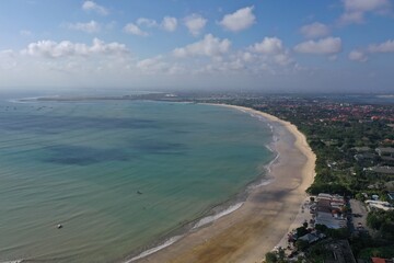Aerial View of Jimbaran Beach with Turquoise Ocean and Coastal Hotels