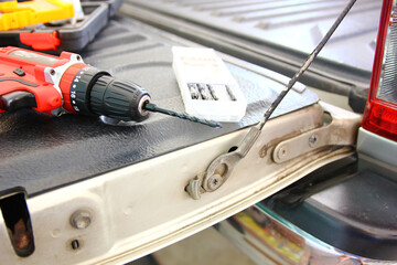 electric hand drill and group of drill bit in plastic box DIY equipment minor repair work at home 