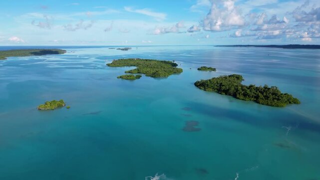 Maratua, Indonesia: Aerial drone footage of islands inside the Maratua turquoise lagoon in the Derawan archipelago in Kalimantan in Indonesia. Shot with a downward and tilt up motion 