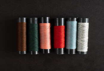 colorful sewing thread on black background