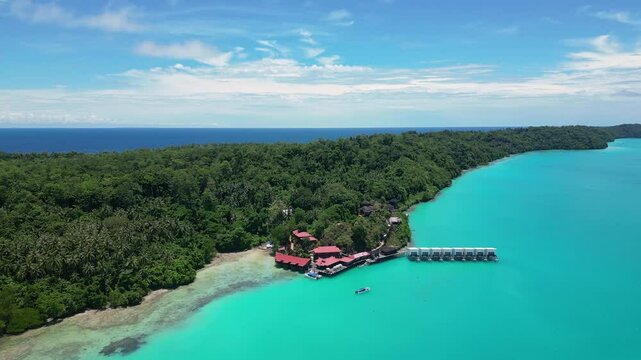 Maratua, Indonesia: Aerial drone footage of a seafront resort with overwater bungalows in the Maratua lagoon in the Derawan islands in Indonesian Borneo. 
