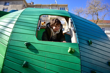 Child enjoying a colorful playground structure in Budapest