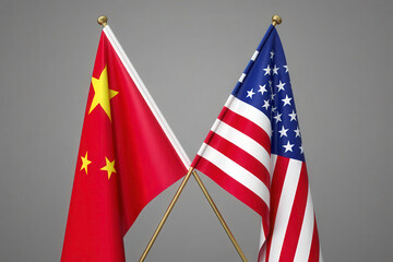 Us and china flags symbolize trade tensions and tariffs