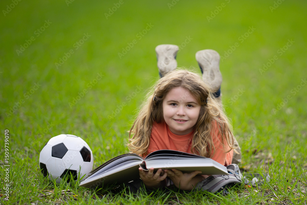 Poster child reading a book in the grass. kid enjoying a book story outdoors. child studying with book in t