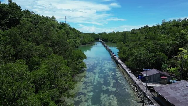 Maratua, Indonesia: Aerial drone footage of a boat delivering supplies to various village and resort in the stunning Maratua lagoon and island in the Derawan archipelago in Indonesia. 