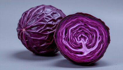 Obraz premium Close-up of Fresh Red Cabbage Whole and Sliced Displaying Juicy Layers and Deep Purple Color for Healthy Vegetable Cooking or Salad Ingredient Use
