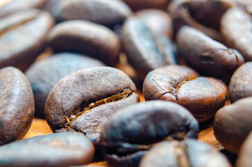Side view of close up of roasted coffee beans that highlights the texture and surface details of the coffee beans. Coffee beans concept