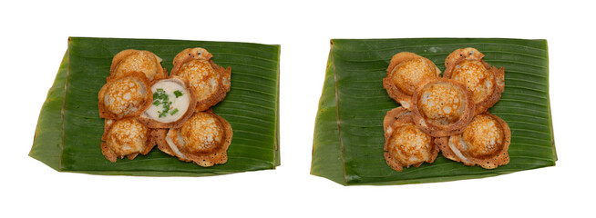 Top view of khanom krok, traditional Thai coconut rice pancakes, served on fresh green banana...