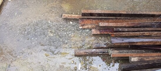 Wet Wooden Planks on Muddy Ground After Rain