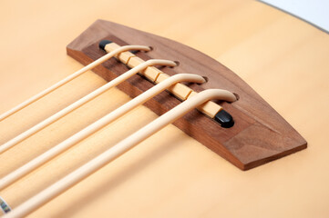 Four-string bass ukulele with wooden body and built-in tuner and pickup.
