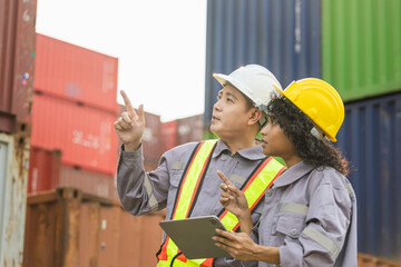Engineers with tablet managing cargo operations, Engineer and foreman dock worker inspecting...