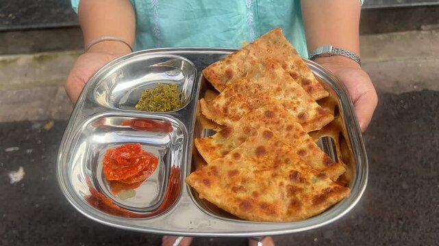 Alu and pyaz paratha served with mango and chilly pickle