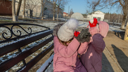 Two little children, quarreling and ready to beat each other crying during their walking in winter.