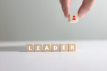 Crafting Leadership A Hand Places A Block Above The Word Leader In Dice Style