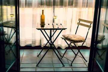 Cozy Indoor Patio Seating Setup with Wine and Natural Lighting