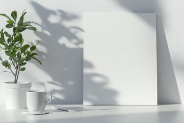 A white frame with a plant and a cup on a table