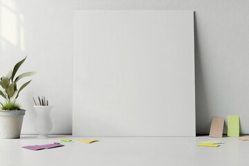 A white wall with a white frame and a potted plant