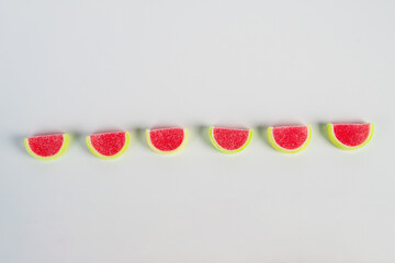 Fruit jelly mixed with sugar on white background