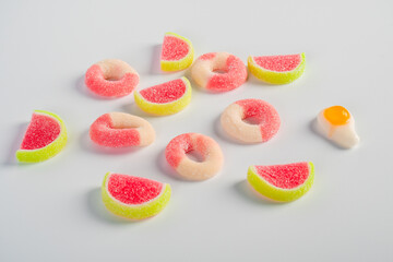 Fruit jelly mixed with sugar on white background