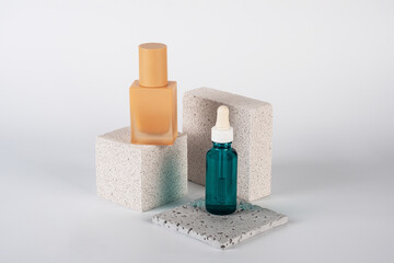 Blue serum bottle and cream sunscreen bottle with white background props