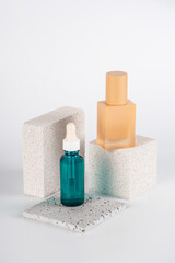 Blue serum bottle and cream sunscreen bottle with white background props
