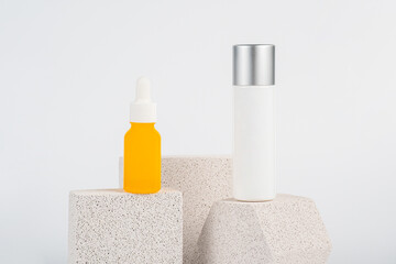 Plastic yellow tube for cream or lotion. Skin care or sunscreen cosmetic with stylish props on...