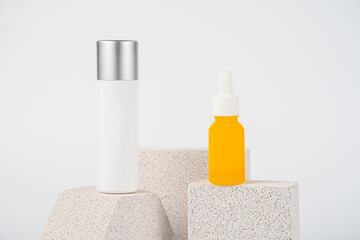 Plastic yellow tube for cream or lotion. Skin care or sunscreen cosmetic with stylish props on...