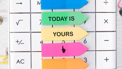 Motivational words TODAY IS YOURS motivating messages are placed on the calculator on bright stickers