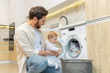 Young man and his little son sorting clothes before putting into washing machine