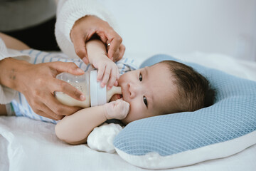Loving parents gently hold their newborn baby, showing warmth, care, protection, and happiness in a close-up family moment of togetherness.