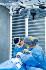 Surgeons in the operating room. Two skilled surgeons conduct a surgical procedure in a modern...