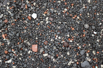 Close-up of a surface covered with black gravel and rock fragments