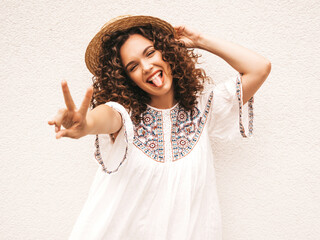 Beautiful smiling model with afro curls hairstyle dressed in summer hipster white dress.Sexy...