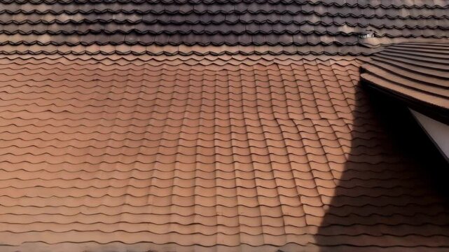 Motion background of overlapping brown and tan roof tiles with organic shapes creating a textured exterior surface