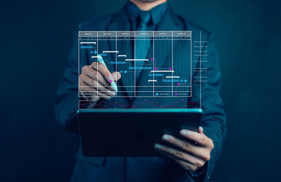 Project manager concept working with Gantt chart schedule to plan tasks and deliverables. Scheduling activities with strategic planning software organizing schedules and important dates. - Powered by Adobe