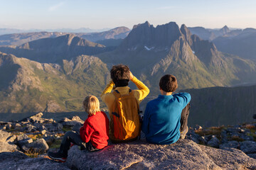 Fototapeta premium Children and adults, family with dog, hiking Grytetippen trail in Senja, Lofoten on a sunny hot summer day