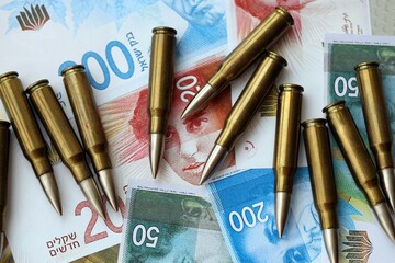 Israel New Shekels banknotes and bullets. The current Israel money bills and ammo