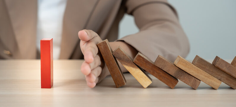 insurance with hands protect domino. hands stop dominoes falling in business crisis. business risk control and planning and strategies to run prevent insurance businesses.