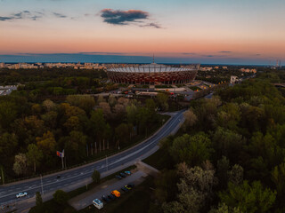 Obraz premium Warsaw city center and skyscrapers in the background Vistula river and Swietokrzyski bridge. Sunset Warsaw aerial view.