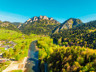Peak Tri Koruny or Trzy Korony during day with green meadow and trees in spring. Pieniny National park in Slovakia and Poland . © Zedspider
